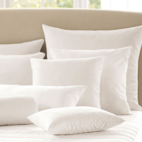 white cushions on bed